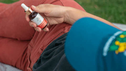 CBD guy with cbd bottle